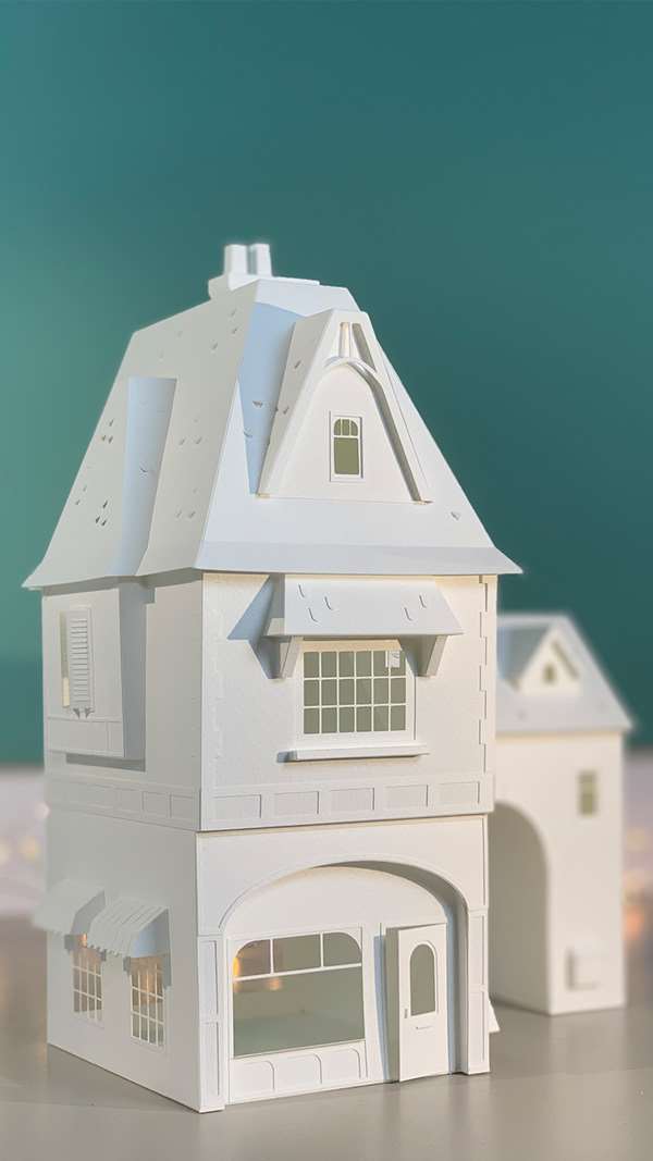 Vera Van Wolferen, Crafted intricate paper sculpture of a magical house, festive lights.