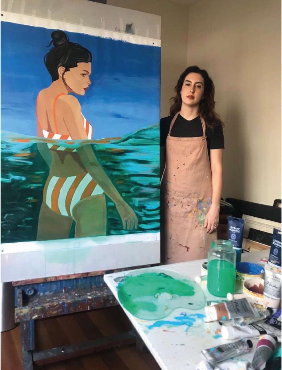 Camila Pinheiro, Camila photographed in her studio with a painting 