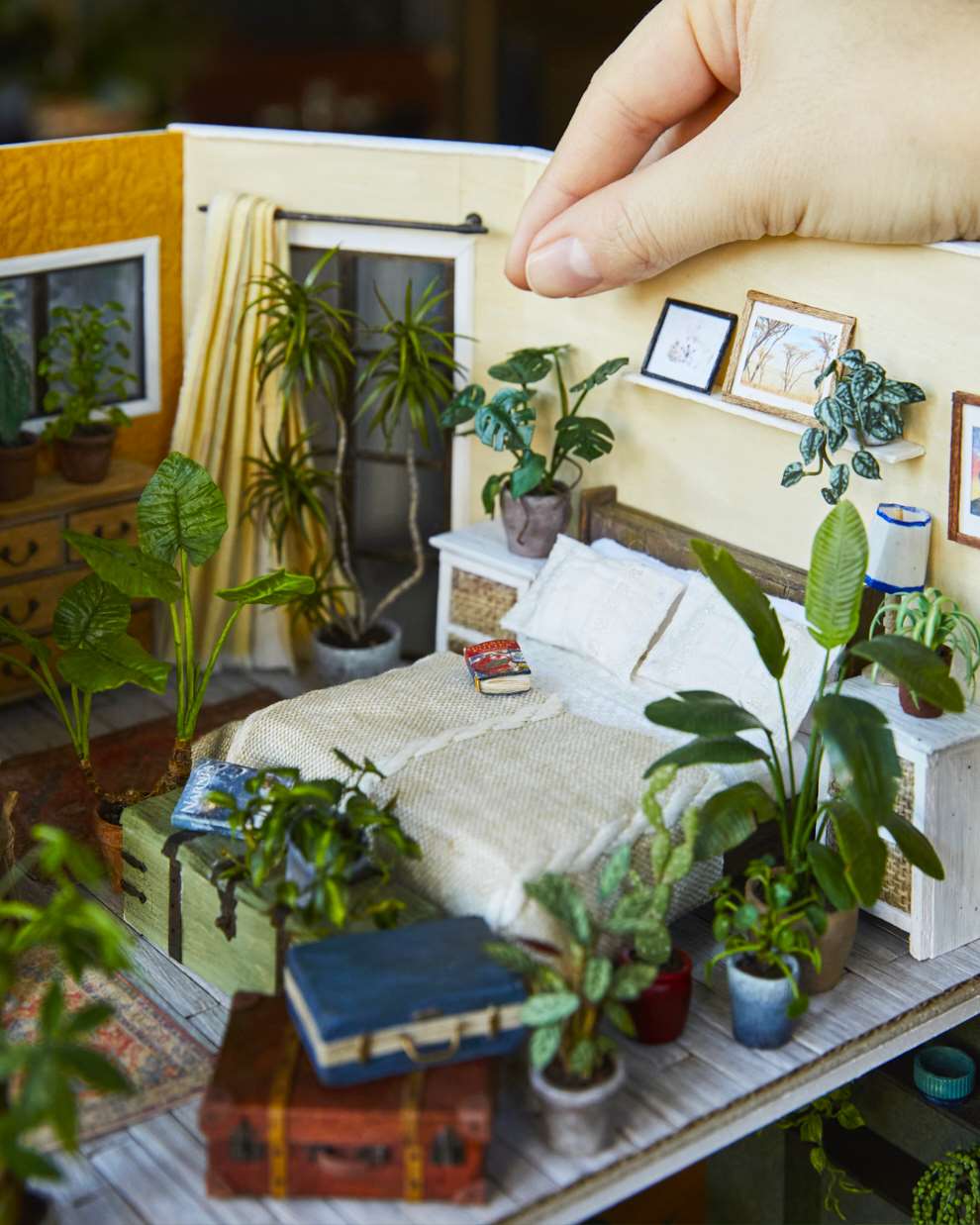 Hannah Lemon, Miniature detailed set design. Bedroom with  a double bed surrounded by houseplants and botanicals. Tiny sculpture made from air drying clay, paper, wood, paint, mixed media.