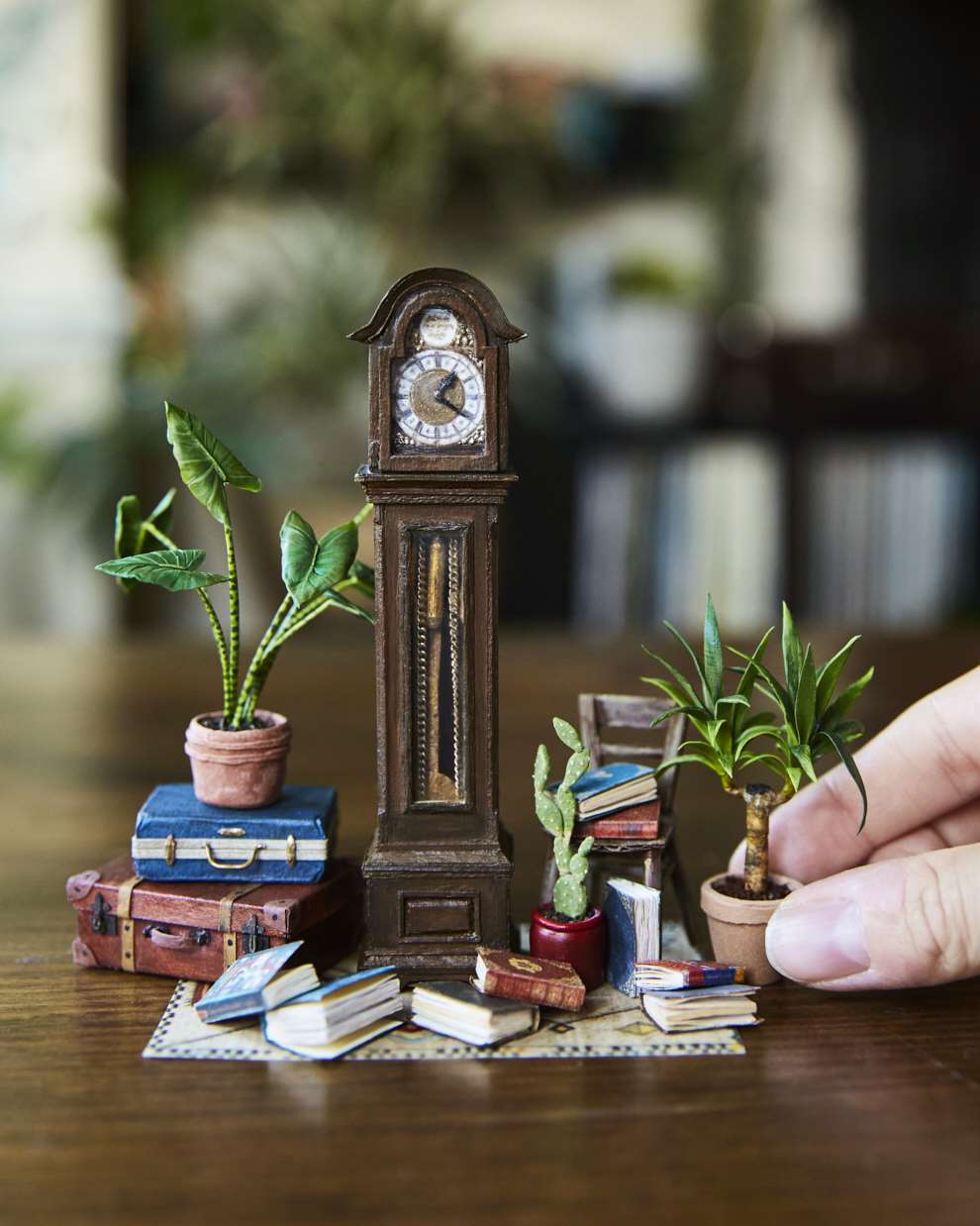 Hannah Lemon, Miniature sculpture of a tiny clock made from air drying clay, wood, paper and paint.