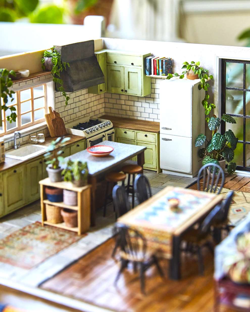 Hannah Lemon, Miniature detailed set design. Warm kitchen with a wooden table surrounded by houseplants and botanicals. Tiny sculpture made from air drying clay, paper, wood, paint, mixed media.