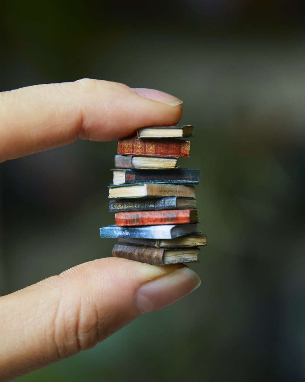 Hannah Lemon, Miniature collection of tiny books made from air drying clay, paper, wood, paint. Mixed media tiny creation.