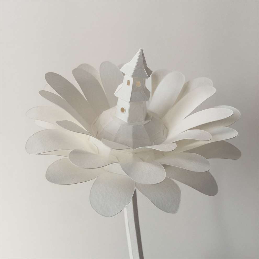 Vera Van Wolferen, Crafted intricate paper sculpture of a flower with a lighthouse inside.