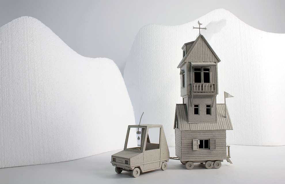 Vera Van Wolferen, Crafted intricate paper sculpture scene of a car and caravan driving through mountains. Winter Magical miniature universe.  Stopmotion paper animation.