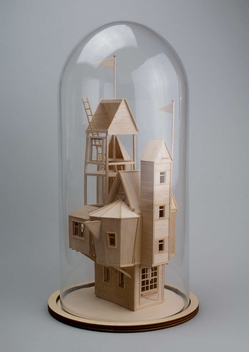 Vera Van Wolferen, Crafted intricate wooden sculpture of a tall house in a glass case. Magical miniature universe.  